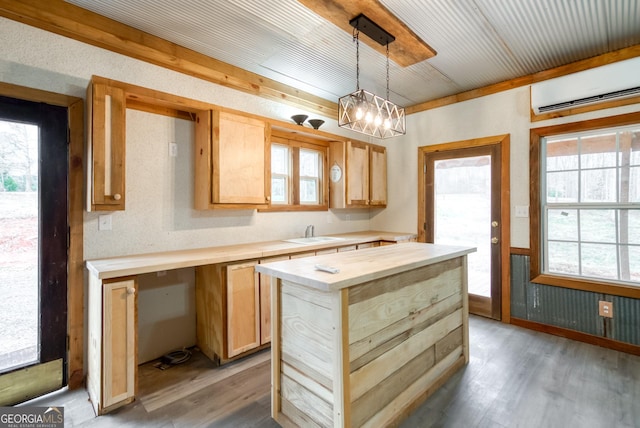 1650 Pierce Dairy Rd, Madison, GA 30650 - kitchen featuring butcher block counters, a wall mounted AC, light wood finished floors, and a sink