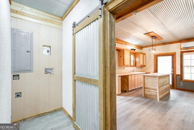 1650 Pierce Dairy Rd, Madison, GA 30650 - interior space with light wood-type flooring, a wall unit AC, electric panel, a barn door, and a sink