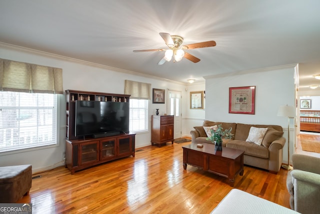 1650 Pierce Dairy Rd, Madison, GA 30650 - living room featuring ornamental molding, a ceiling fan, visible vents, light wood finished floors, and baseboards