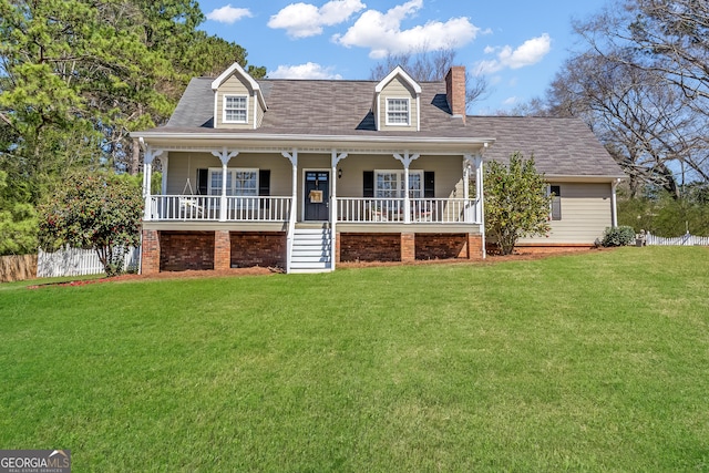 new england style home with a front yard, fence, covered porch, and a chimney