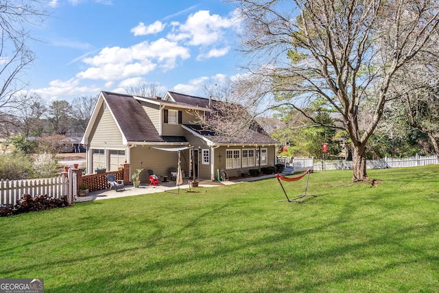 back of property with a patio area, fence, roof with shingles, and a lawn