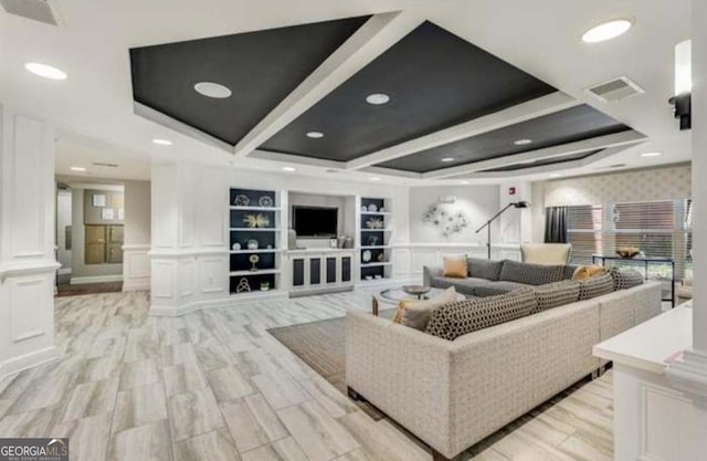 living room with recessed lighting, built in shelves, light wood-style floors, and visible vents