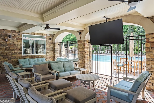 view of patio featuring outdoor lounge area, a community pool, fence, and ceiling fan