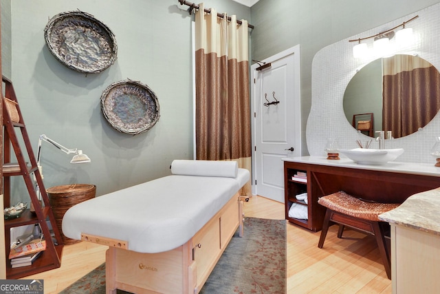 full bathroom featuring wood finished floors and vanity