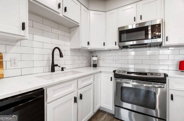 kitchen with white cabinetry, appliances with stainless steel finishes, and a sink