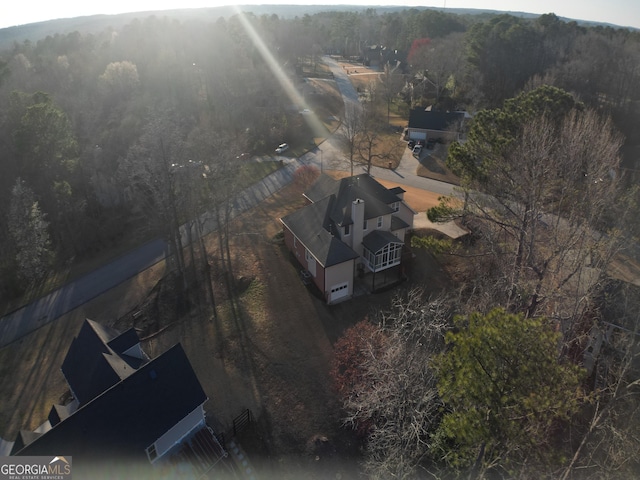 bird's eye view with a wooded view