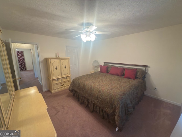 bedroom with ceiling fan, carpet flooring, baseboards, and a textured ceiling