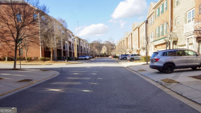 view of road featuring curbs, a residential view, and sidewalks