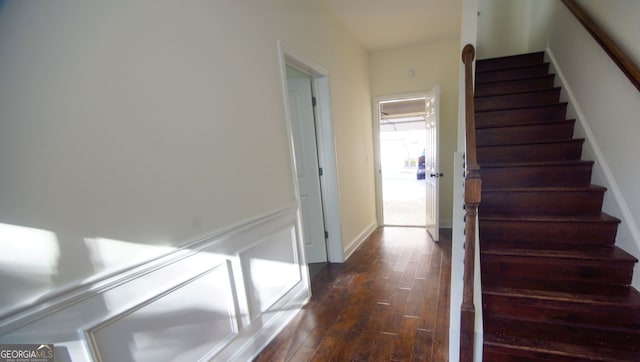 stairway featuring hardwood / wood-style floors and baseboards