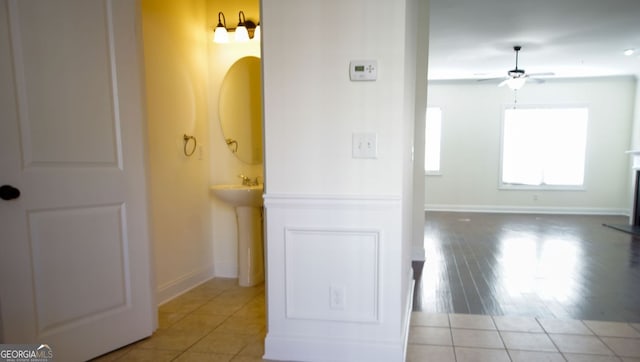 bathroom featuring tile patterned floors, baseboards, and ceiling fan