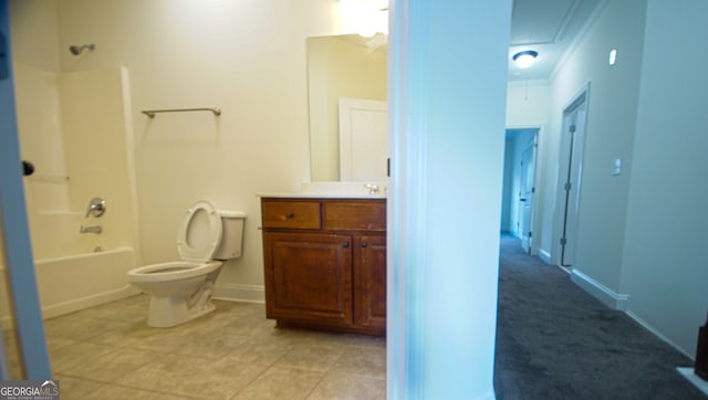 full bathroom featuring tile patterned floors, toilet, shower / washtub combination, baseboards, and vanity