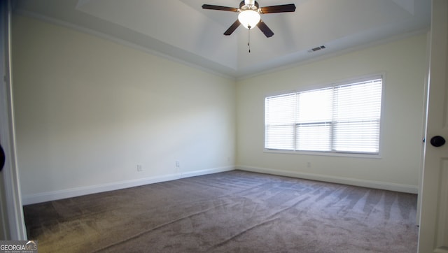 unfurnished room featuring visible vents, ceiling fan, baseboards, carpet, and a tray ceiling