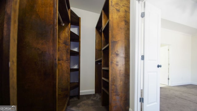 corridor with carpet flooring and baseboards