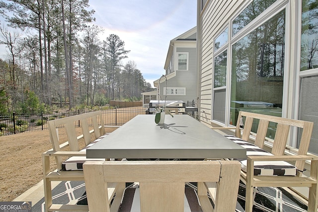 wooden deck featuring outdoor dining space and fence