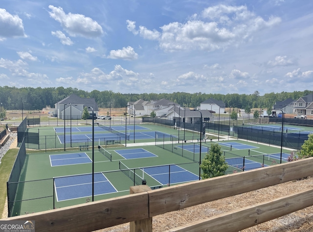 view of tennis court featuring fence