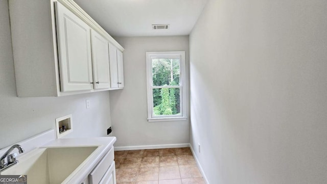 838 Natchez Valley Trce NE, Grayson, GA 30017 - laundry area with washer hookup, cabinet space, hookup for an electric dryer, and light tile patterned flooring