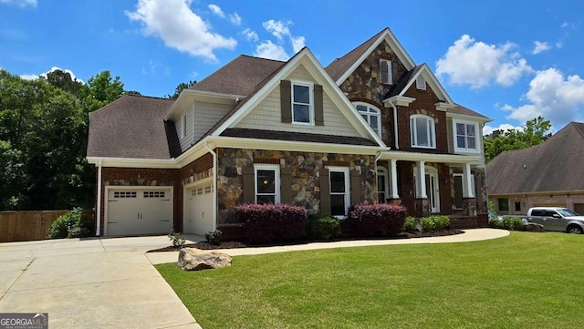 craftsman house featuring a front yard, stone siding, driveway, and roof with shingles