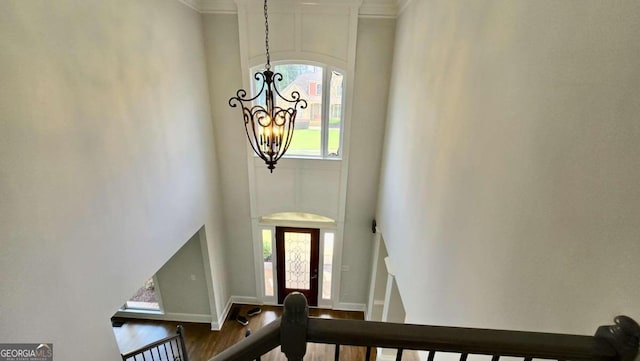 838 Natchez Valley Trce NE, Grayson, GA 30017 - staircase featuring a chandelier, healthy amount of natural light, crown molding, and wood finished floors