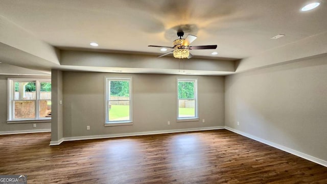 838 Natchez Valley Trce NE, Grayson, GA 30017 - spare room featuring dark wood-type flooring, ceiling fan, recessed lighting, and a raised ceiling
