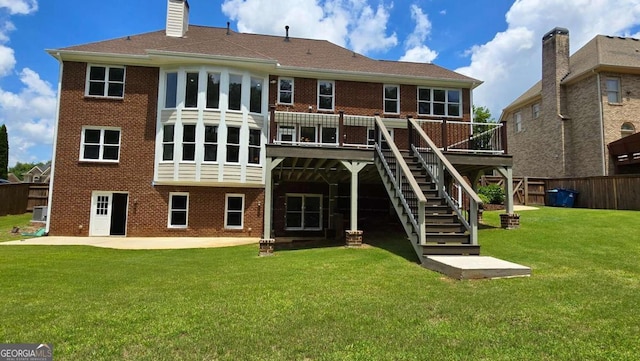 838 Natchez Valley Trce NE, Grayson, GA 30017 - back of property featuring brick siding, a patio, stairs, a wooden deck, and a chimney