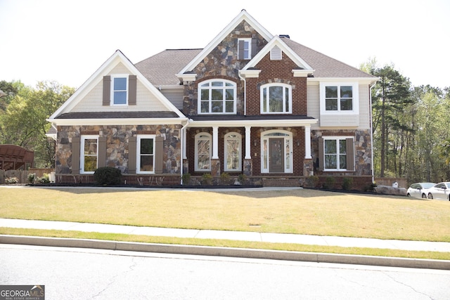838 Natchez Valley Trce NE, Grayson, GA 30017 - craftsman house featuring stone siding, a front lawn, and a porch
