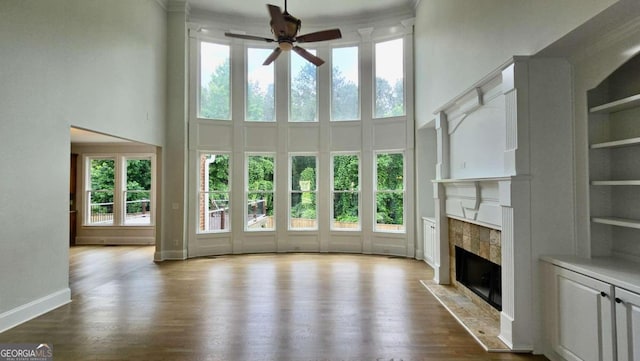 838 Natchez Valley Trce NE, Grayson, GA 30017 - unfurnished living room featuring a towering ceiling, healthy amount of natural light, and a ceiling fan