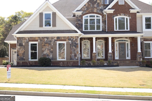 838 Natchez Valley Trce NE, Grayson, GA 30017 - craftsman house with stone siding, covered porch, a front lawn, and a shingled roof