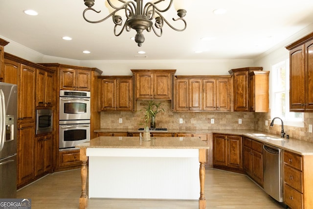 838 Natchez Valley Trce NE, Grayson, GA 30017 - kitchen featuring appliances with stainless steel finishes, light wood-style flooring, a center island, tasteful backsplash, and ornamental molding