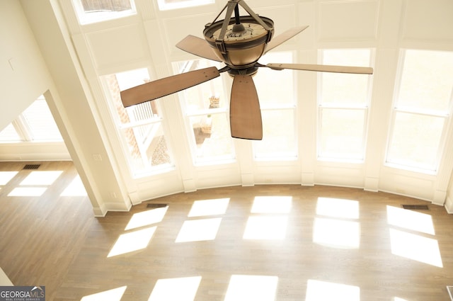 838 Natchez Valley Trce NE, Grayson, GA 30017 - detailed view of wood finished floors, a decorative wall, and a ceiling fan