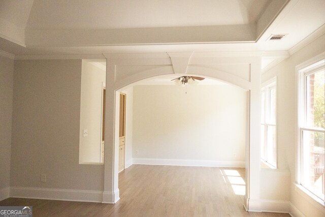 838 Natchez Valley Trce NE, Grayson, GA 30017 - unfurnished room with arched walkways, light wood-type flooring, a ceiling fan, and ornamental molding