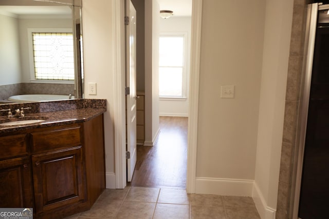 838 Natchez Valley Trce NE, Grayson, GA 30017 - full bathroom featuring ornamental molding, vanity, a bath, and tile patterned flooring