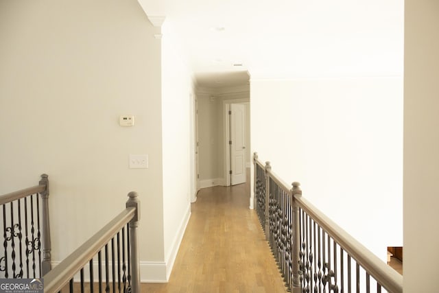 838 Natchez Valley Trce NE, Grayson, GA 30017 - hallway featuring an upstairs landing, light wood-style flooring, and crown molding