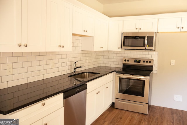 838 Natchez Valley Trce NE, Grayson, GA 30017 - kitchen with stainless steel appliances, dark countertops, decorative backsplash, and dark wood-style flooring