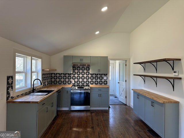 kitchen with butcher block countertops, open shelves, a sink, stainless steel electric range oven, and lofted ceiling