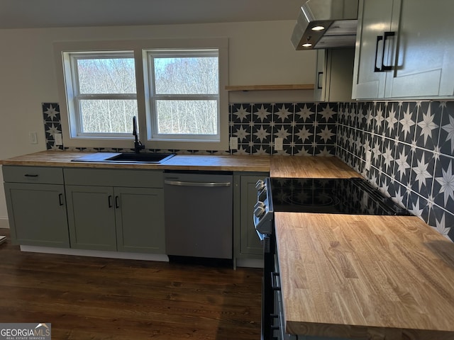 kitchen featuring a sink, under cabinet range hood, dishwasher, wood counters, and dark wood-style flooring