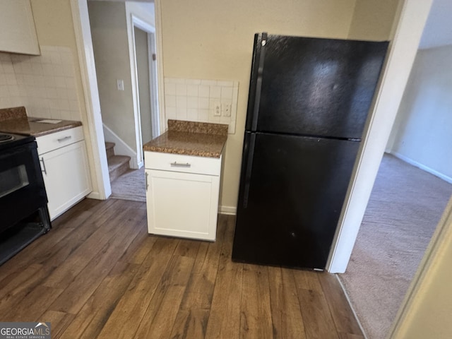 2976 Nelson Dr, Duluth, GA 30096 - kitchen featuring black appliances, decorative backsplash, dark wood-style floors, and white cabinets
