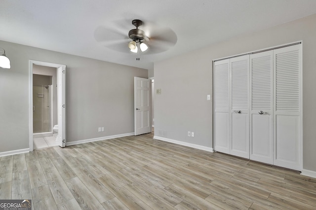 unfurnished bedroom with a closet, baseboards, and light wood-style floors