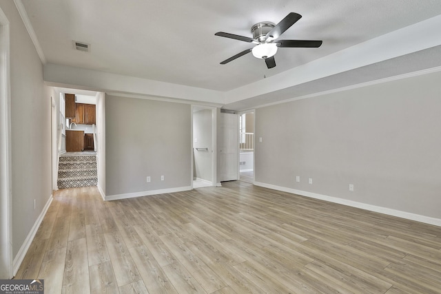 interior space featuring light wood-type flooring, baseboards, and a ceiling fan