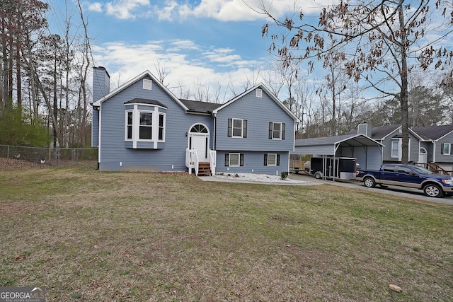 view of front of home featuring a front lawn, entry steps, fence, a carport, and a chimney