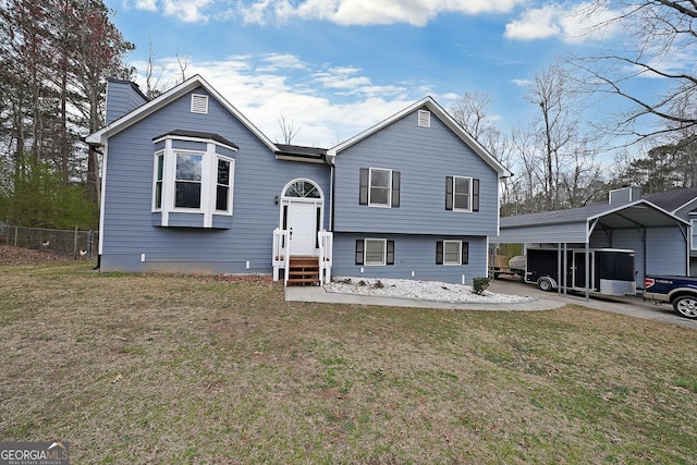 view of front of property with a detached carport, fence, a front yard, and a chimney