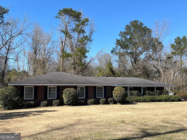 ranch-style home with a front lawn