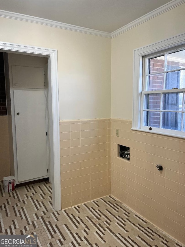 bathroom with tile walls, ornamental molding, wainscoting, and tile patterned flooring