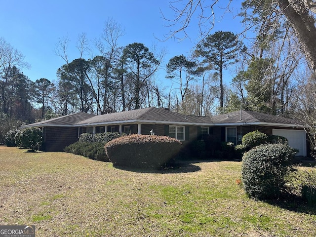 view of front of house with an attached garage and a front yard