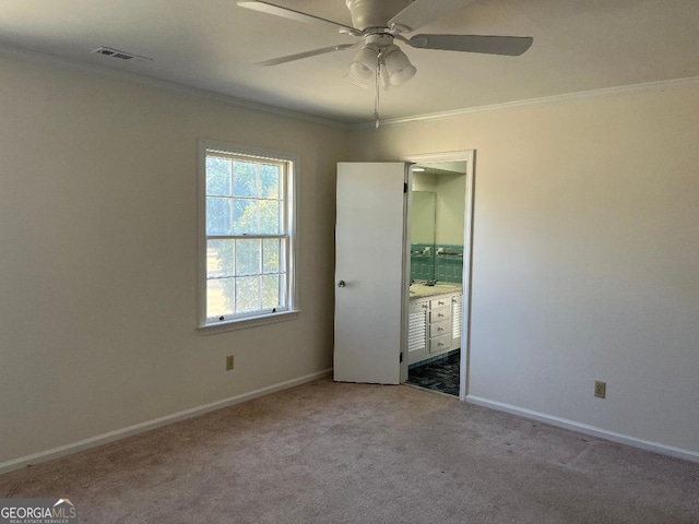 unfurnished bedroom with crown molding, carpet, visible vents, and baseboards