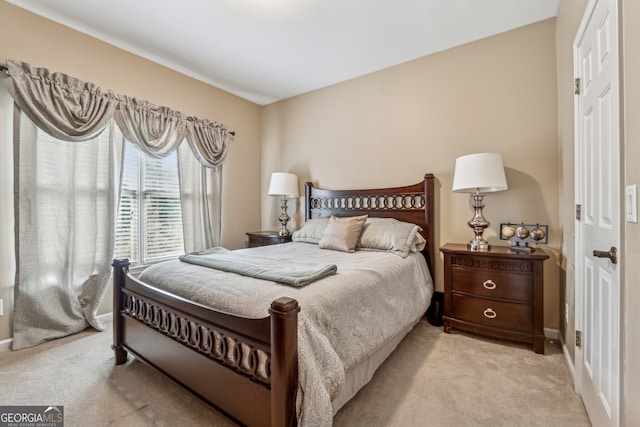 bedroom featuring baseboards and light carpet