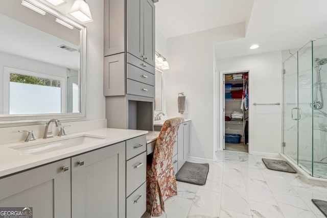 bathroom with a marble finish shower, visible vents, marble finish floor, and vanity