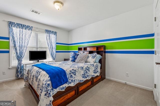 carpeted bedroom featuring visible vents and baseboards