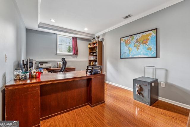 office featuring wood finished floors, visible vents, and baseboards