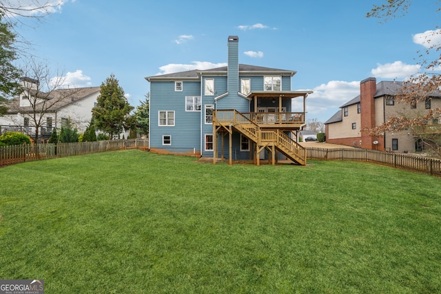 rear view of property with a fenced backyard, stairs, a yard, a wooden deck, and a chimney