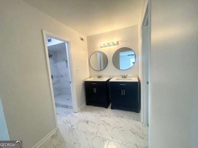full bath with a shower stall, vanity, marble finish floor, baseboards, and visible vents